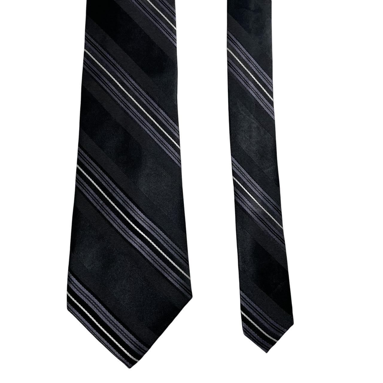 DKNY black silk tie with vintage striped pattern and logo detail.