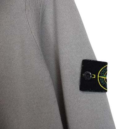 Stone Island grey wool knit jumper with logo patch and subtle wear marks.