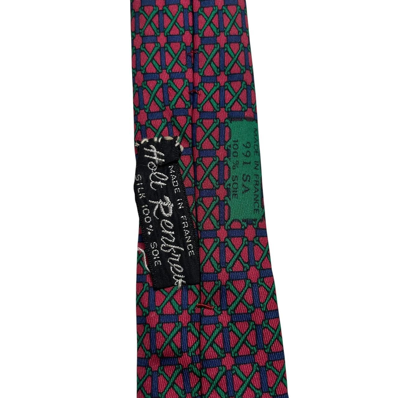 Hermes silk tie featuring geometric print in red, blue, and green colors.
