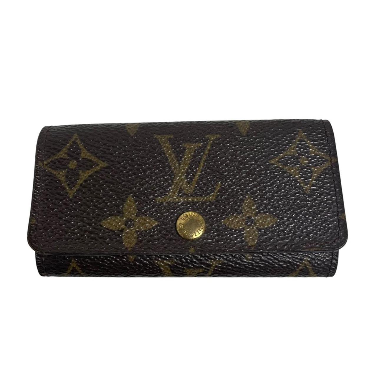 Louis Vuitton brown and tan monogram canvas key case with logo detail.