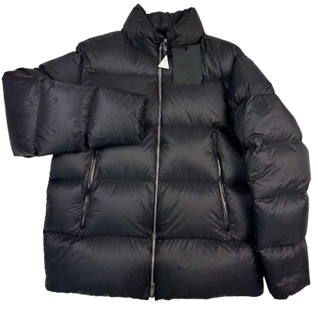 Moncler black nylon down puffer jacket with logo patch and quilted design.