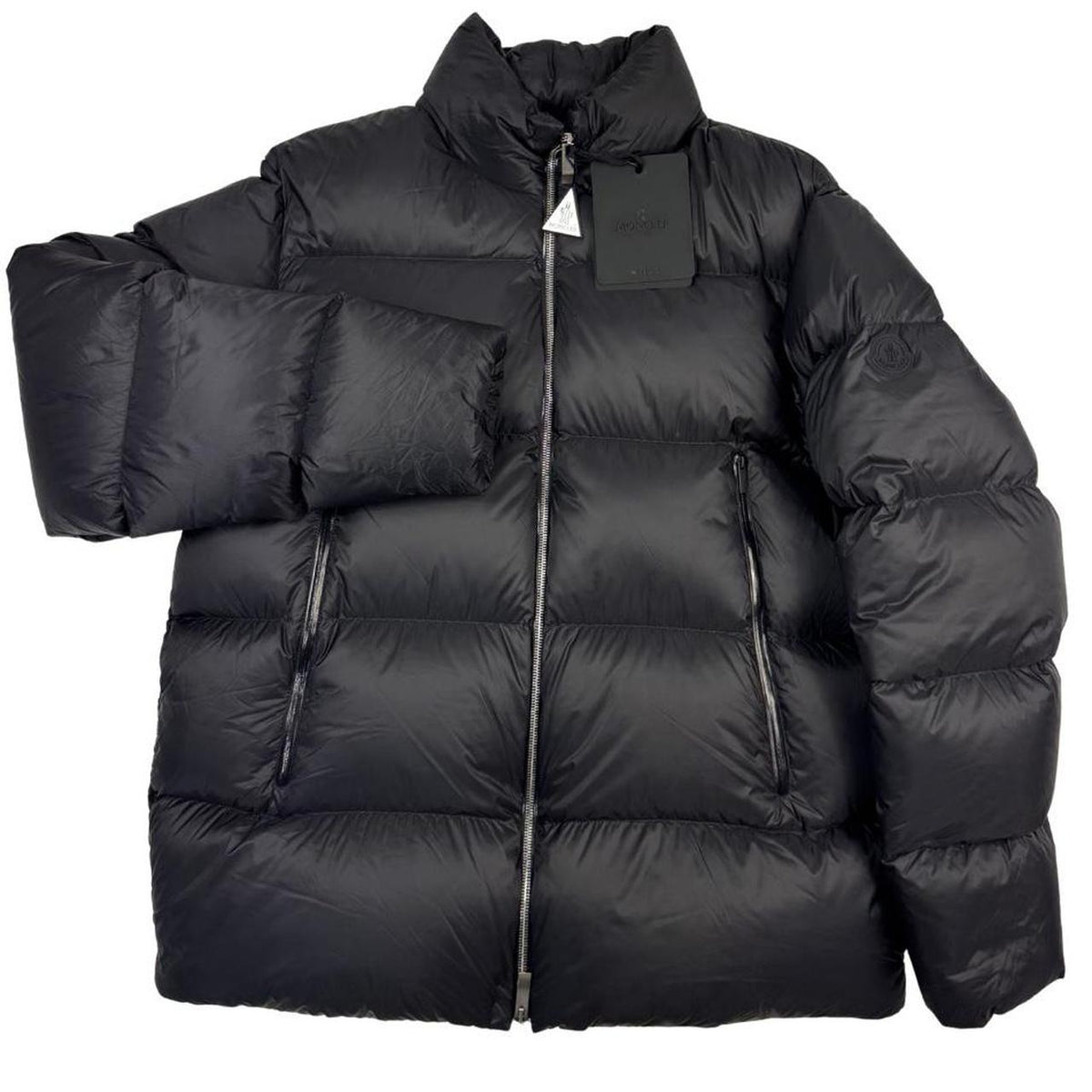 Moncler black nylon down puffer jacket with logo patch and quilted design.