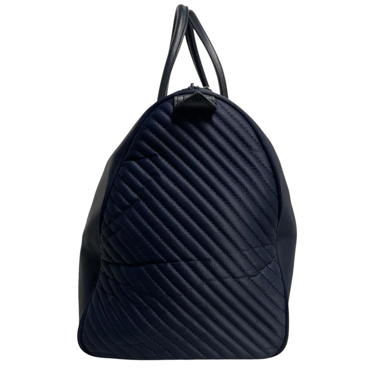 Yves Saint Laurent navy blue duffel bag embossed logo nylon material with handles.