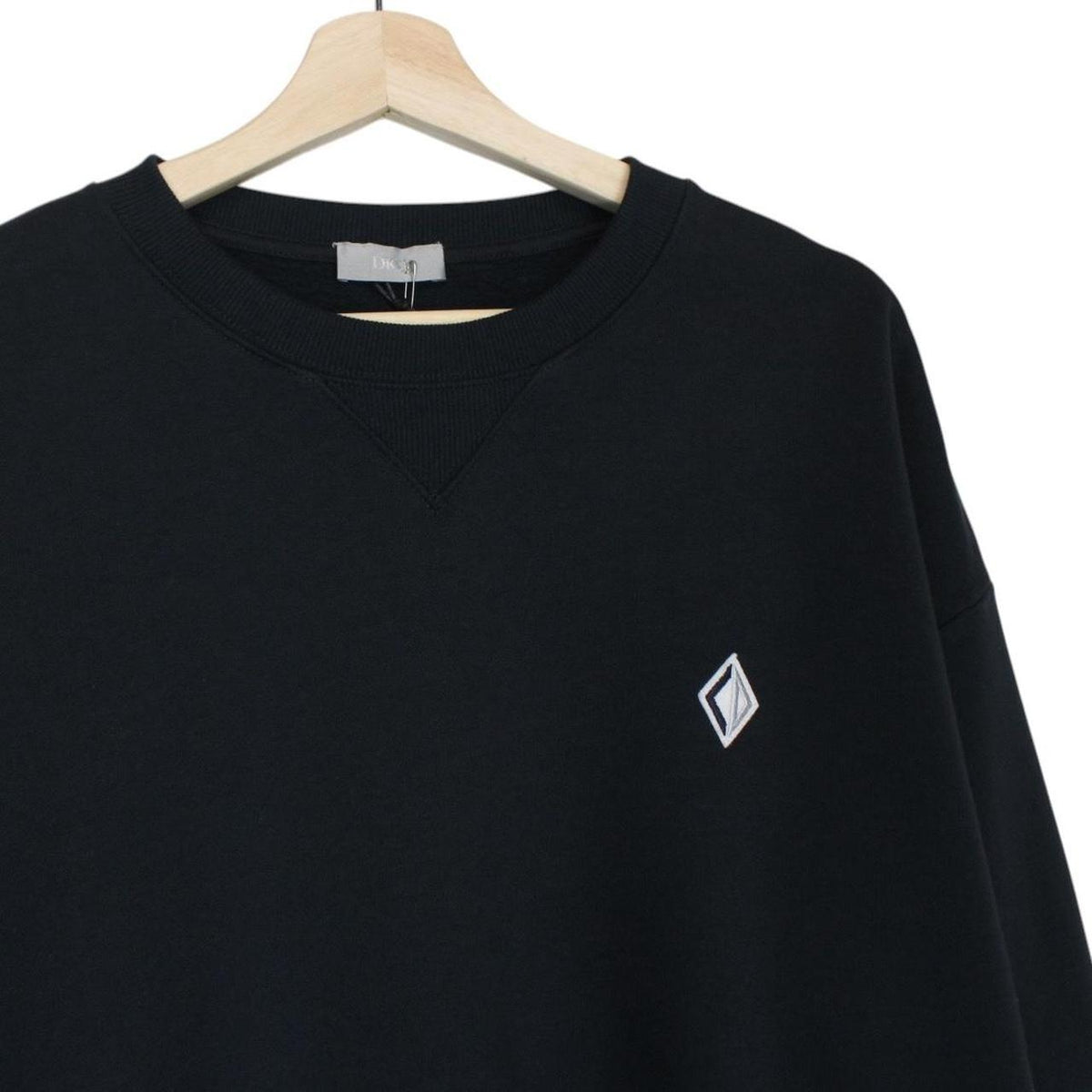 Dior navy blue sweatshirt featuring embroidered CD icon logo on cotton material.