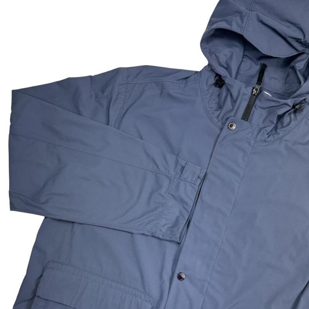 Stone Island blue hooded jacket with logo patch and micro twill fabric.