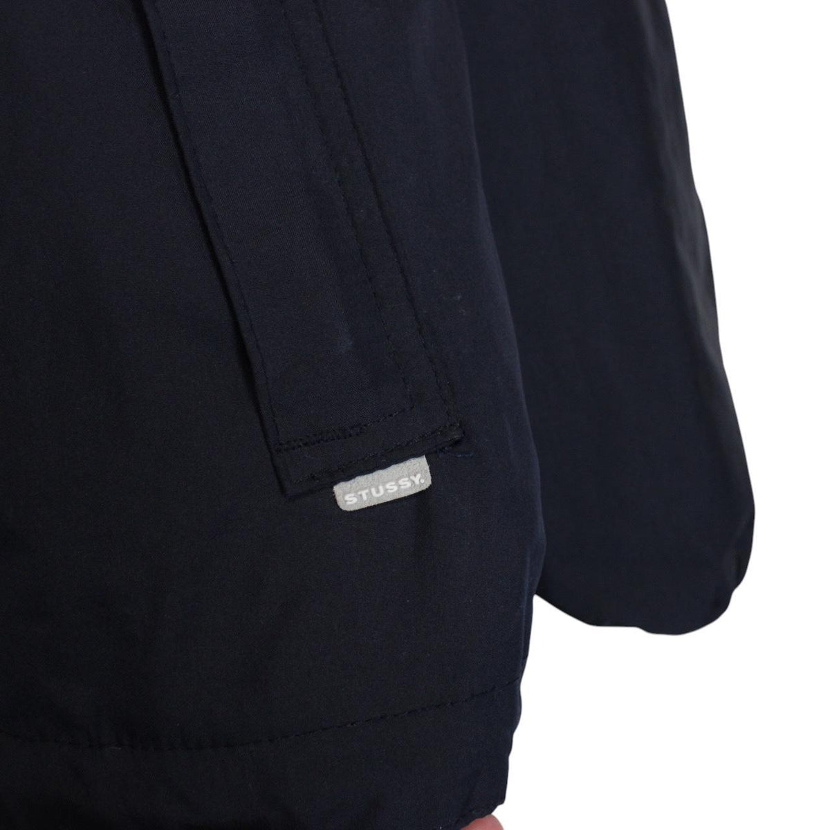 Stüssy reversible nylon jacket in grey and navy blue with logo detailing.