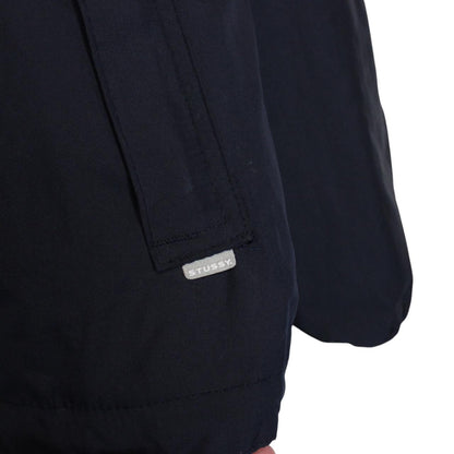 Stüssy reversible nylon jacket in grey and navy blue with logo detailing.