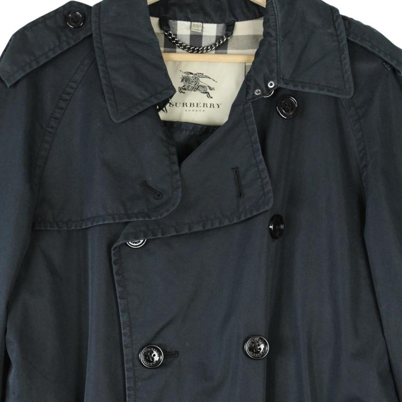 Burberry beige double breasted belted trench coat with classic check lining and logo detail.
