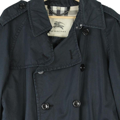 Burberry beige double breasted belted trench coat with classic check lining and logo detail.