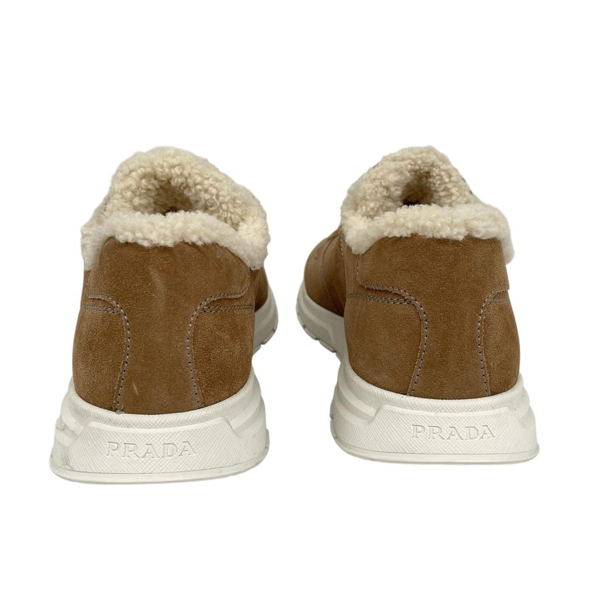 Prada brown suede trainers with shearling lining and logo detail.