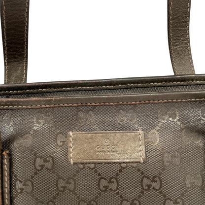 Gucci khaki green duffel bag with metallic monogram canvas and leather trim details.