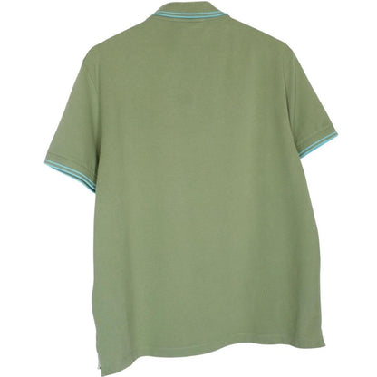 Stone Island green polo shirt with embroidered compass logo and cotton material.