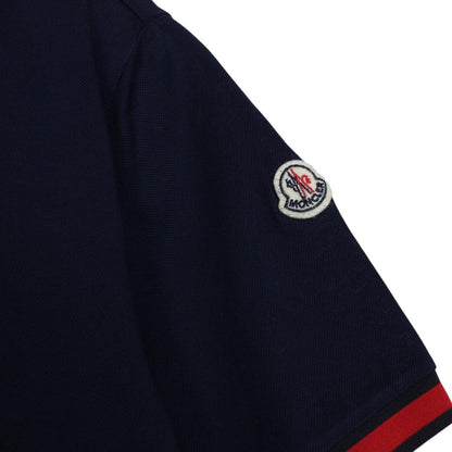 Moncler navy blue short sleeve polo shirt with embroidered logo and cotton material.