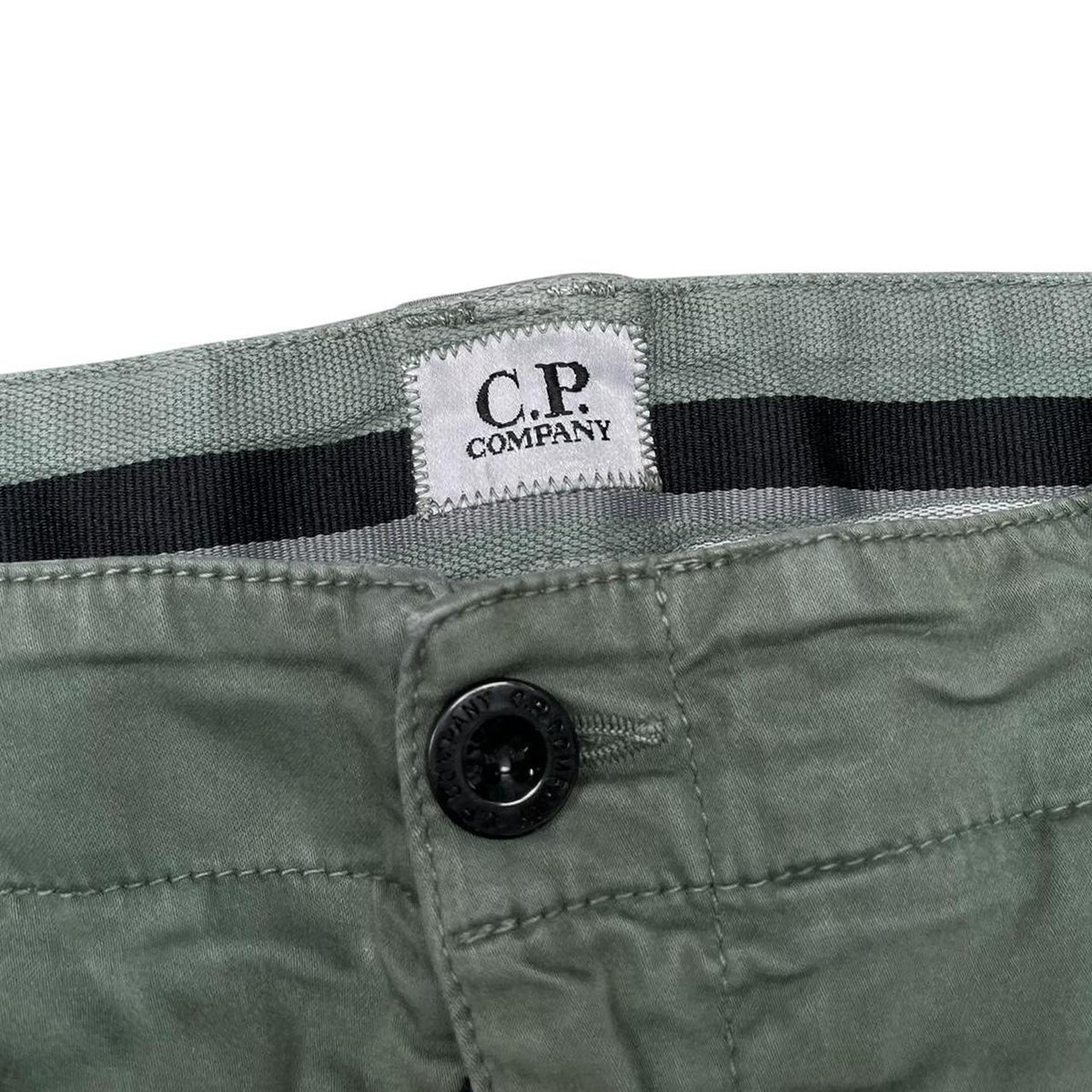 CP Company green cargo shorts with lens detail and cotton material, size XL.