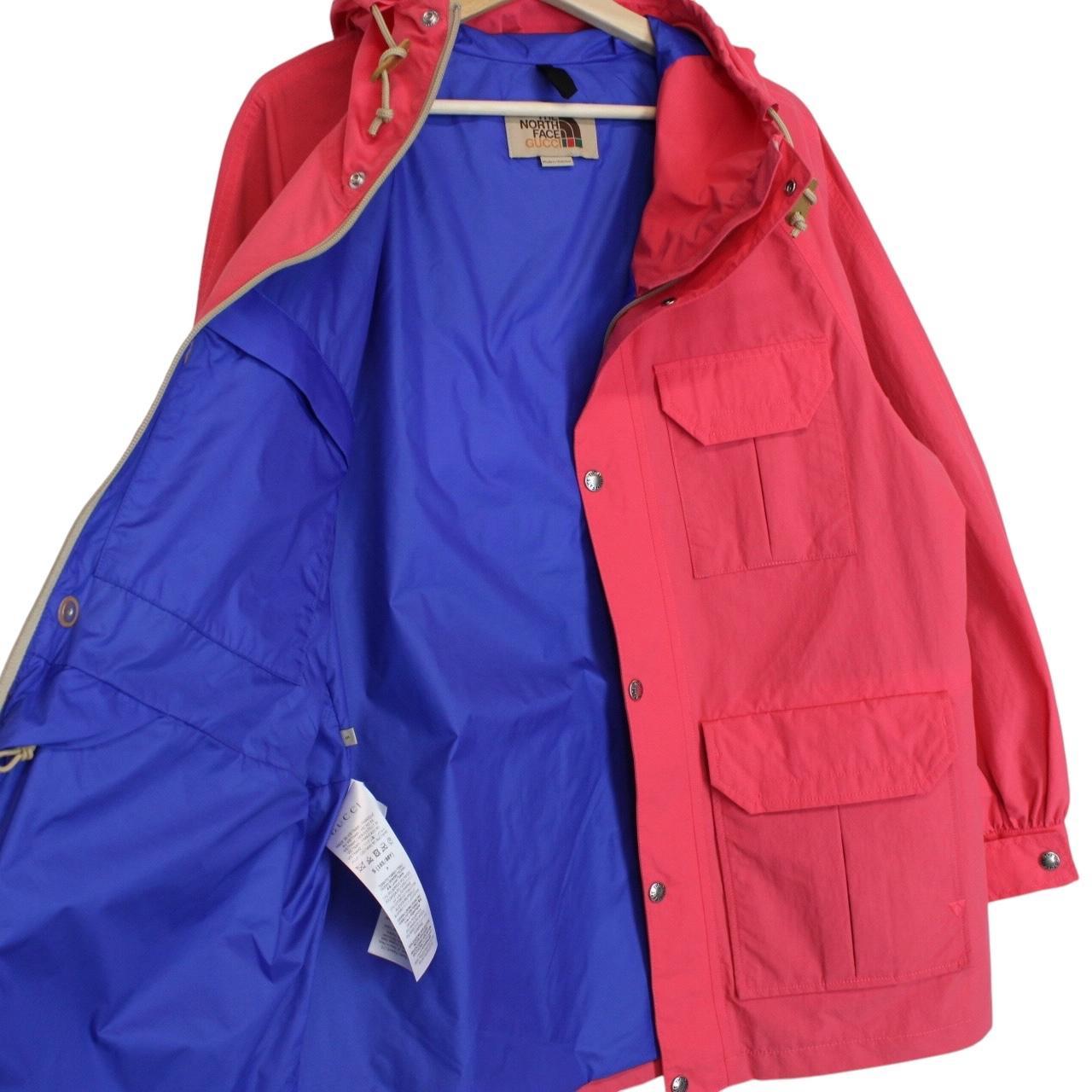 Gucci pink windbreaker jacket with North Face logo and full zip design.