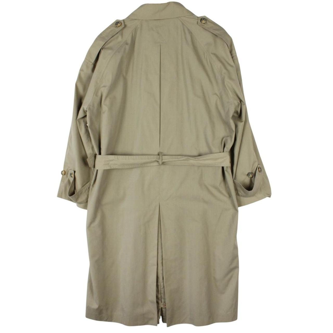 Yves Saint Laurent beige trench coat with single breasted design and belted waist.