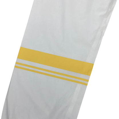 Stone Island white and yellow trousers with logo patch and RE-T fit design.
