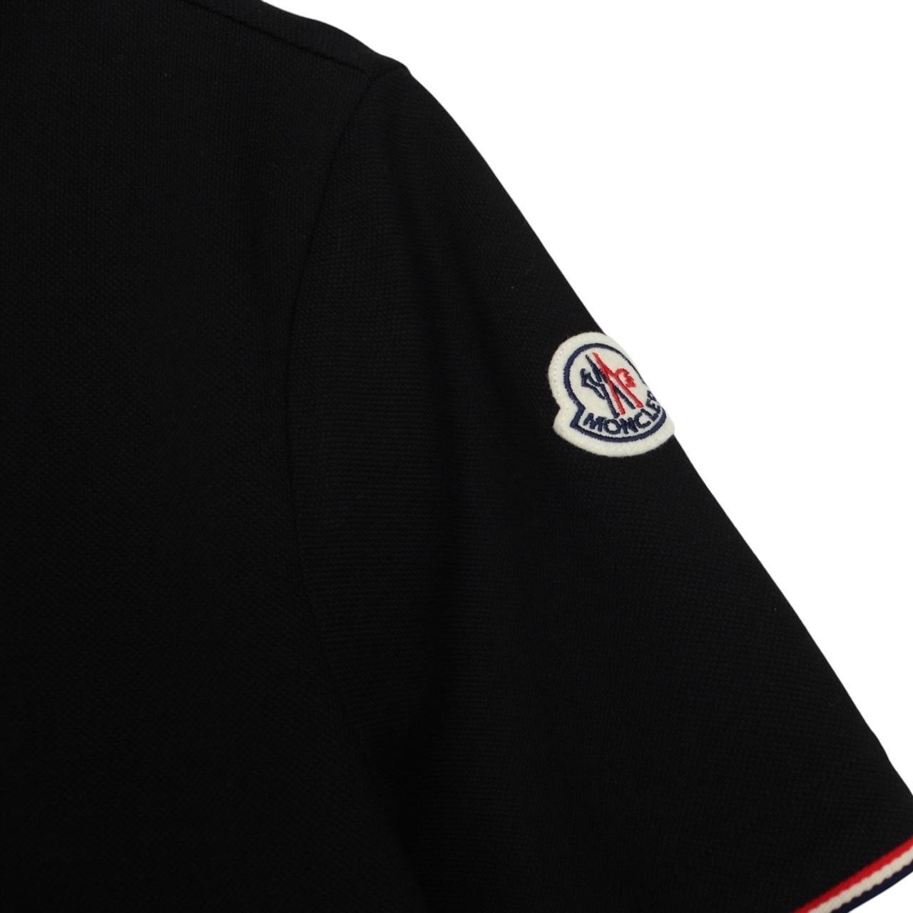 Moncler black short sleeve polo shirt with embroidered logo and cotton material.