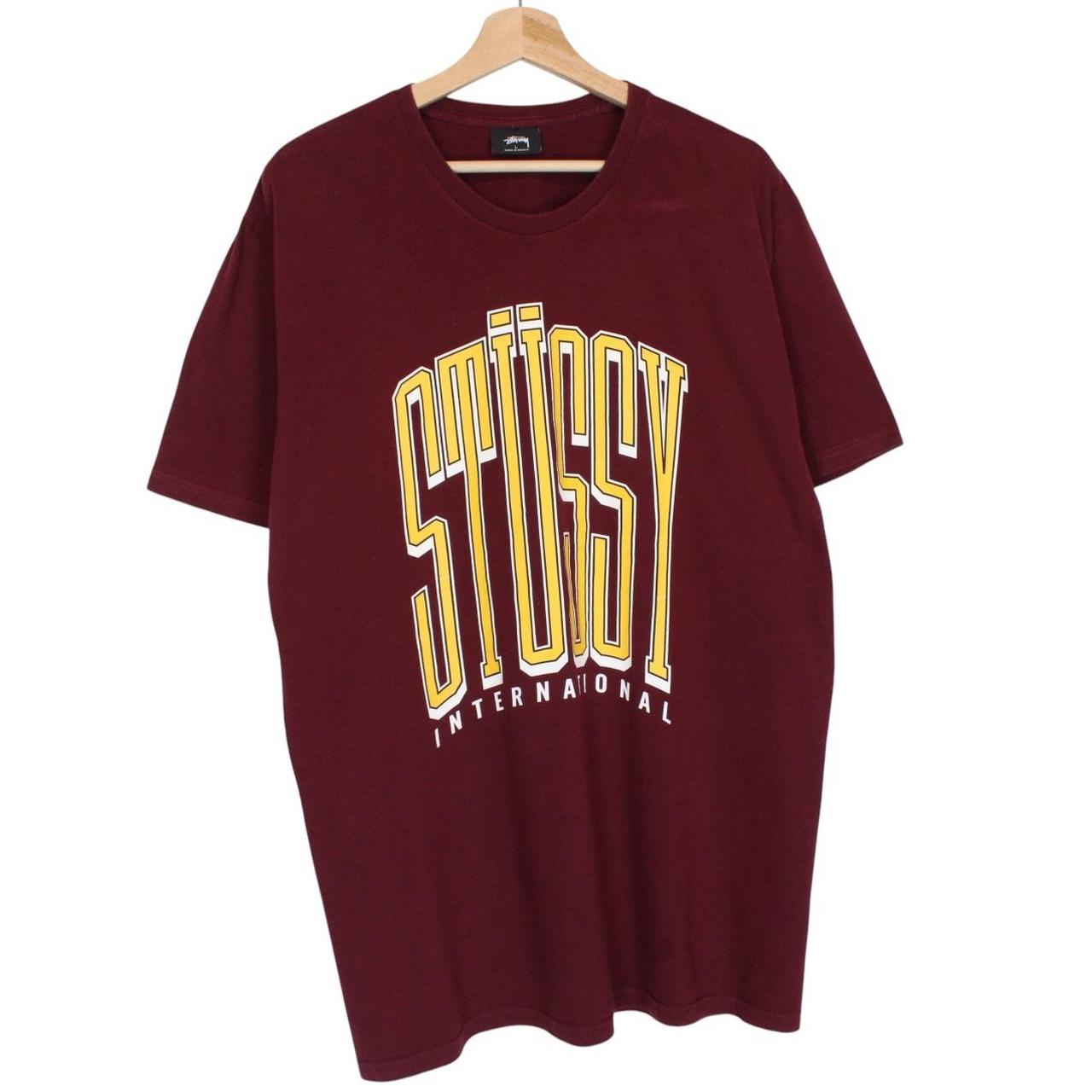 Stüssy burgundy pocket t-shirt with yellow college print and faint shoulder mark.