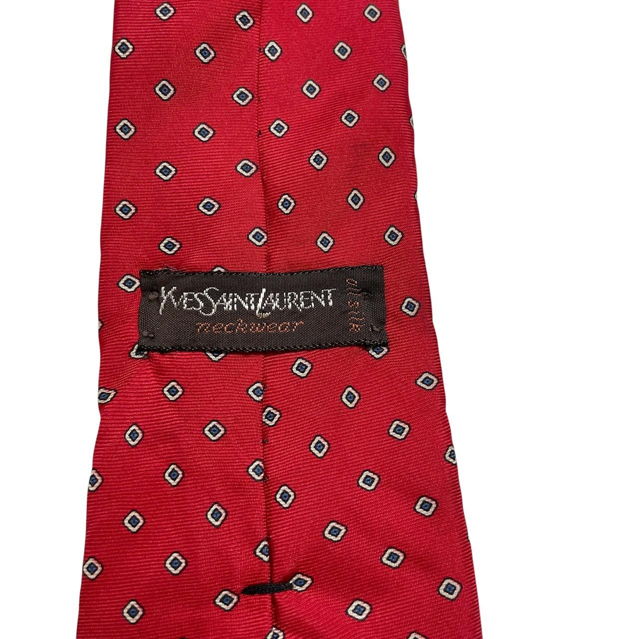 Yves Saint Laurent red silk tie with subtle sheen and vintage design.