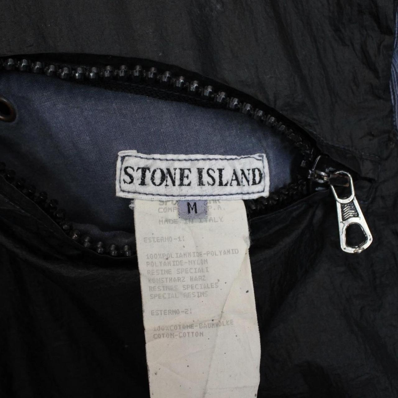 Stone Island navy blue reversible vest with green edge and logo patch detail.