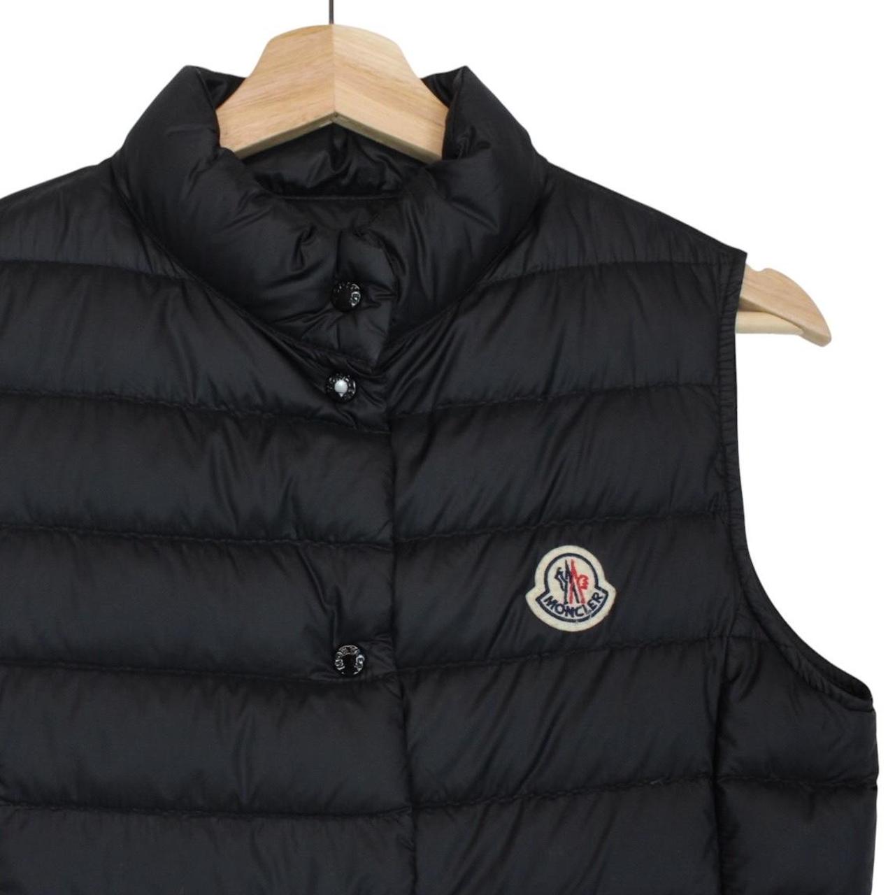 Moncler black quilted shell down gilet with logo patch and zip pockets.