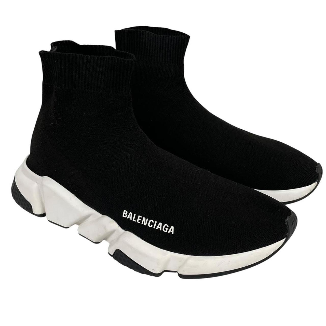 Balenciaga Speed 2 black and white trainers with logo detailing and cotton material.