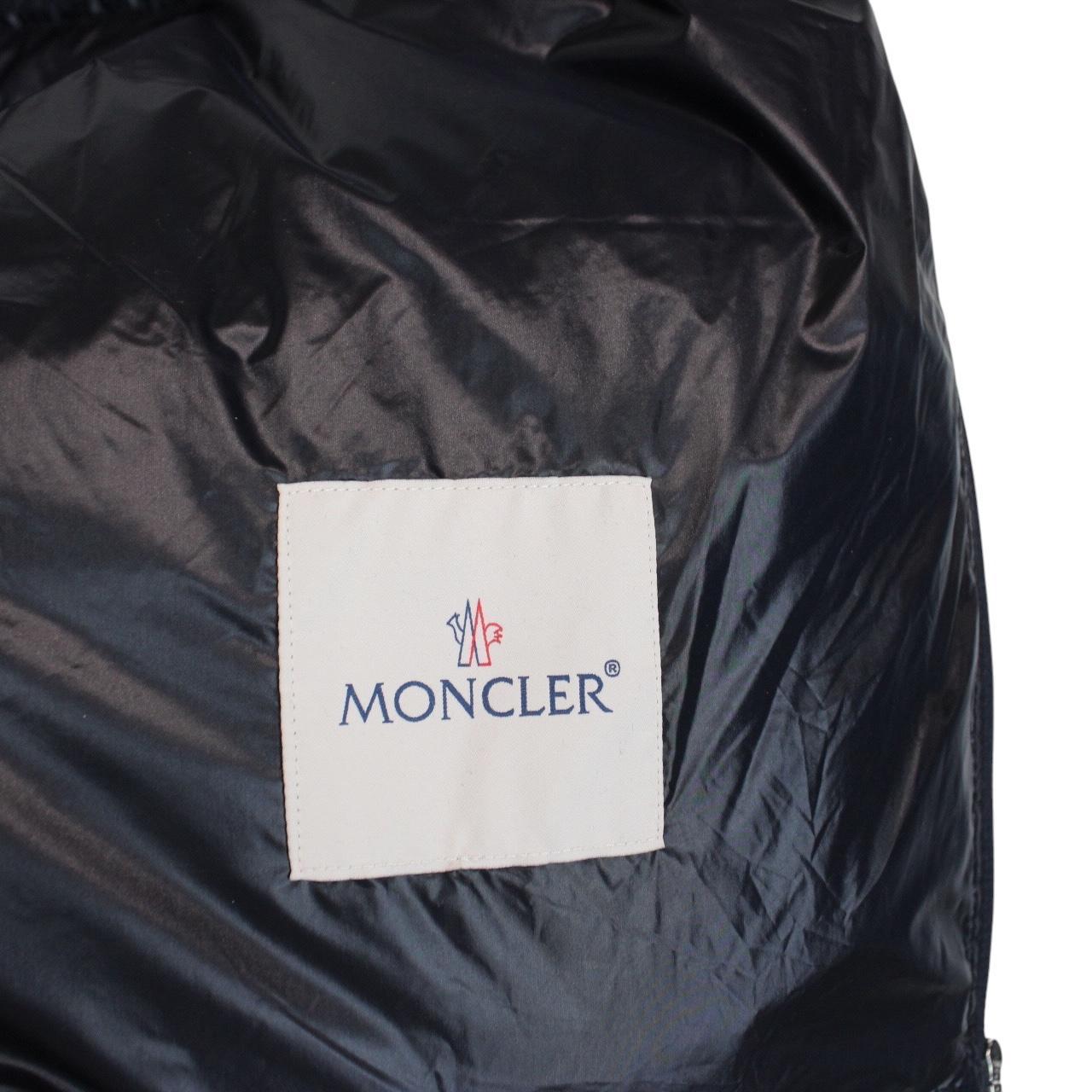 Moncler navy blue down gilet with logo patch and quilted design.
