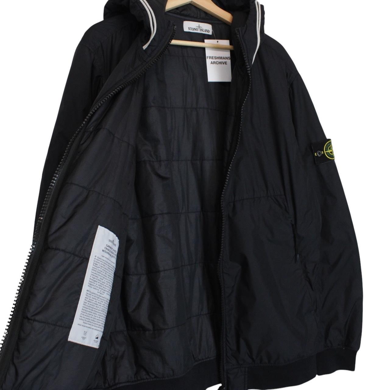 Stone Island black jacket with crinkle texture and logo patch on sleeve.