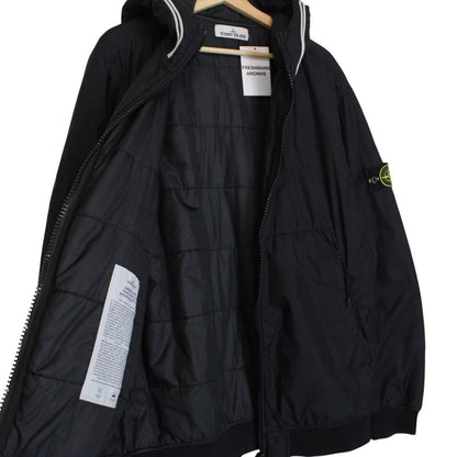 Stone Island black jacket with crinkle texture and logo patch on sleeve.