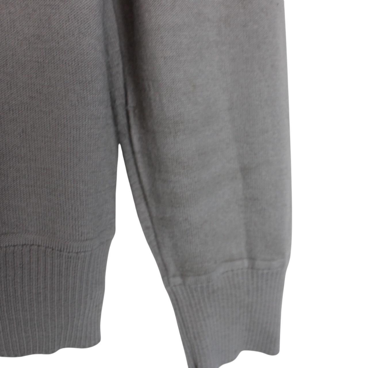 Stone Island grey wool knit jumper with logo patch and subtle wear marks.