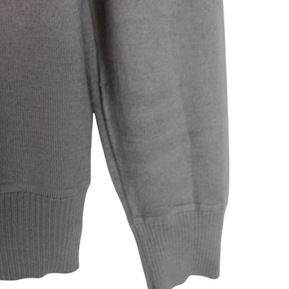 Stone Island grey wool knit jumper with logo patch and subtle wear marks.