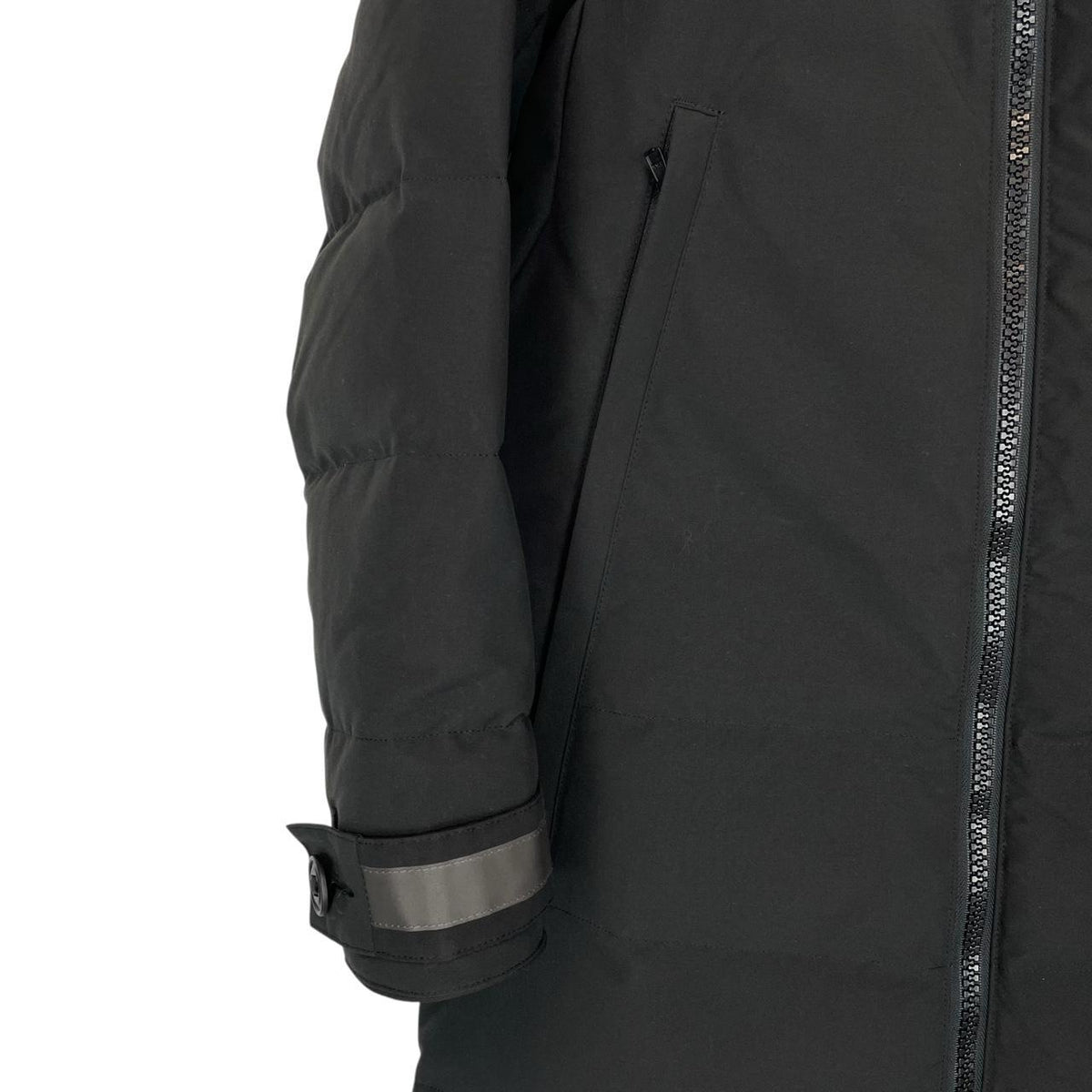 Canada Goose black parka with fur trim, logo patch, and down insulation.