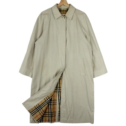 Burberry beige trench coat featuring iconic Nova Check pattern and single breasted design.