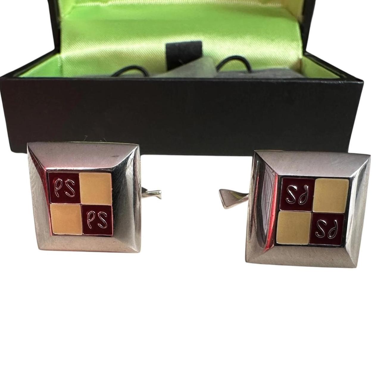Paul Smith silver cufflinks with beveled edge and engraved "PS" logo.