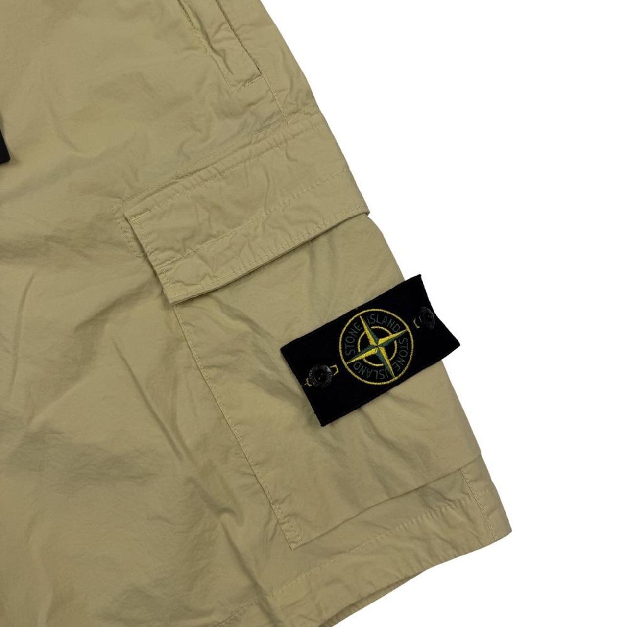 Stone Island beige cargo shorts with logo patch and multiple pockets in cotton material.