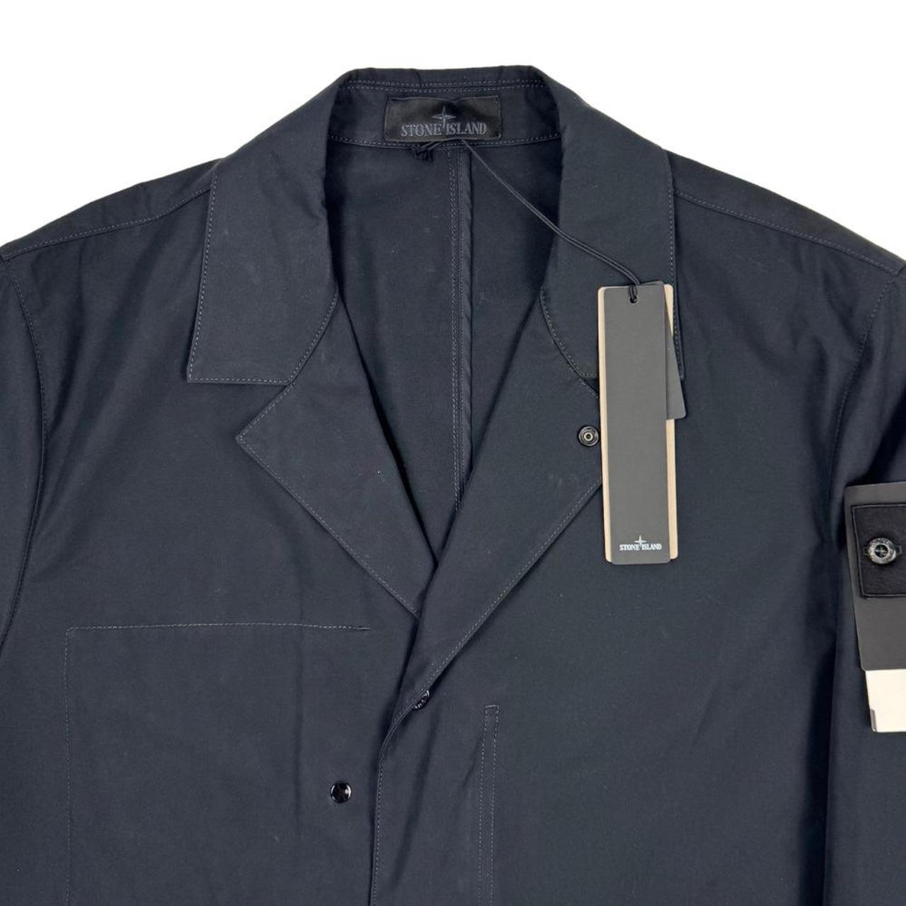 Stone Island navy blue jacket weatherproof cotton canvas with ghost logo detail.