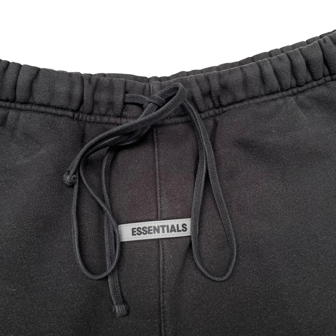 Essentials black jogger shorts cotton material with faded detailing and logo.