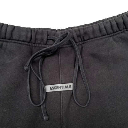 Essentials black jogger shorts cotton material with faded detailing and logo.