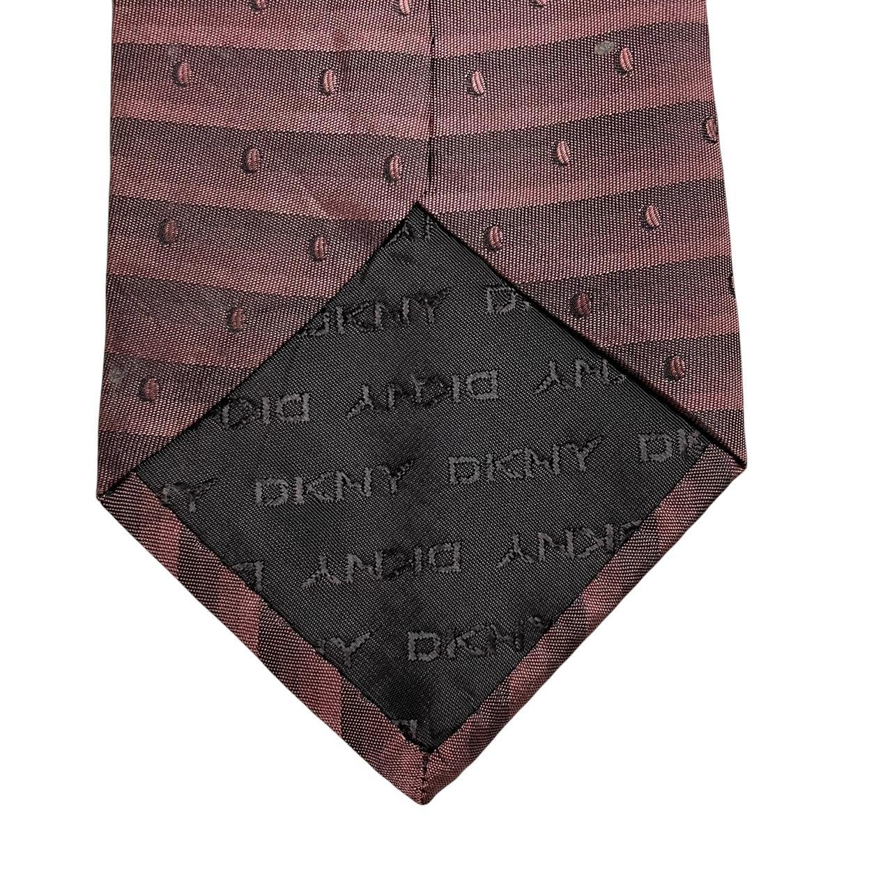 DKNY burgundy silk tie with striped pattern and logo detail.