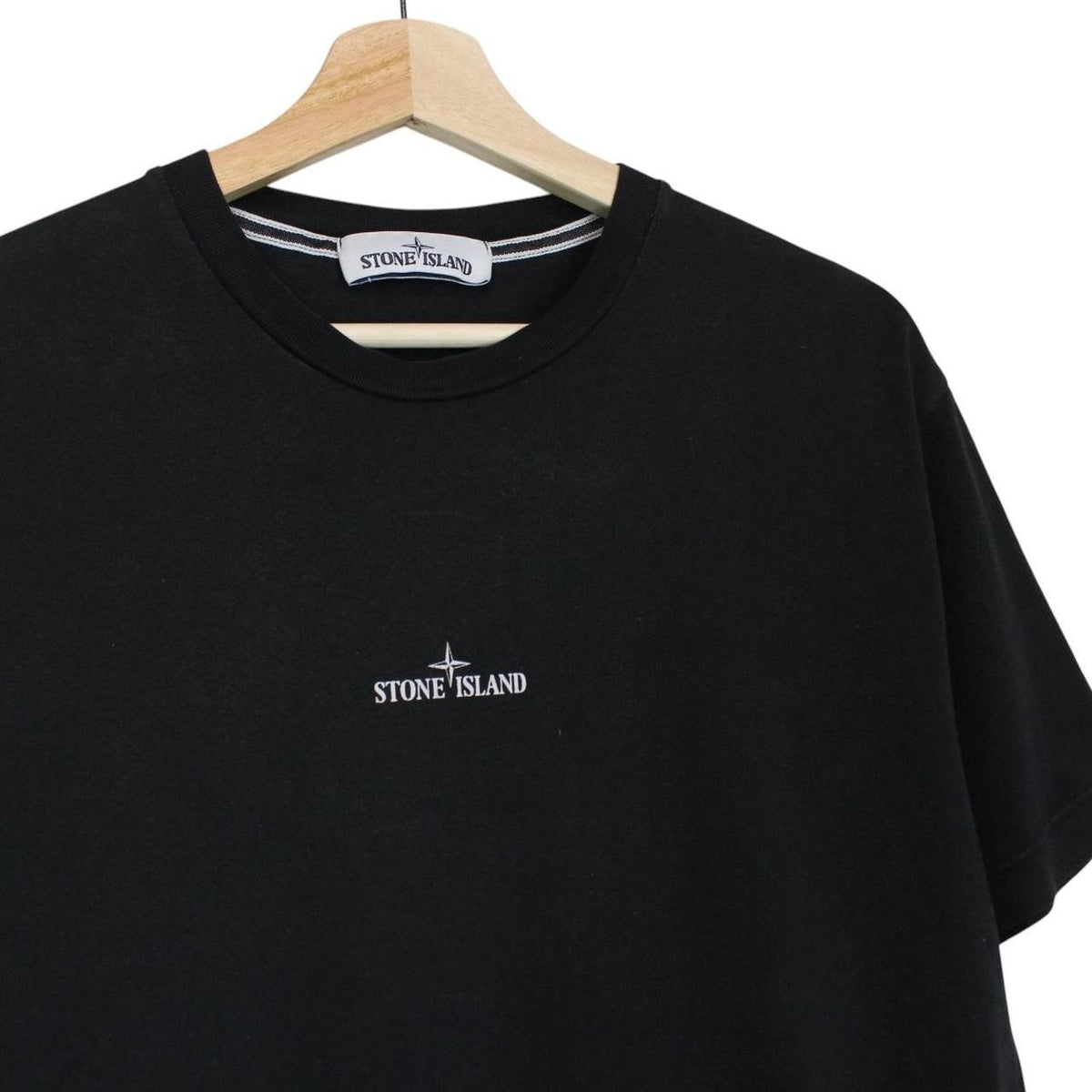Stone Island black short sleeve t-shirt with logo print on chest and cotton material.