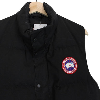 Canada Goose black down gilet with logo patch and durable exterior shell.