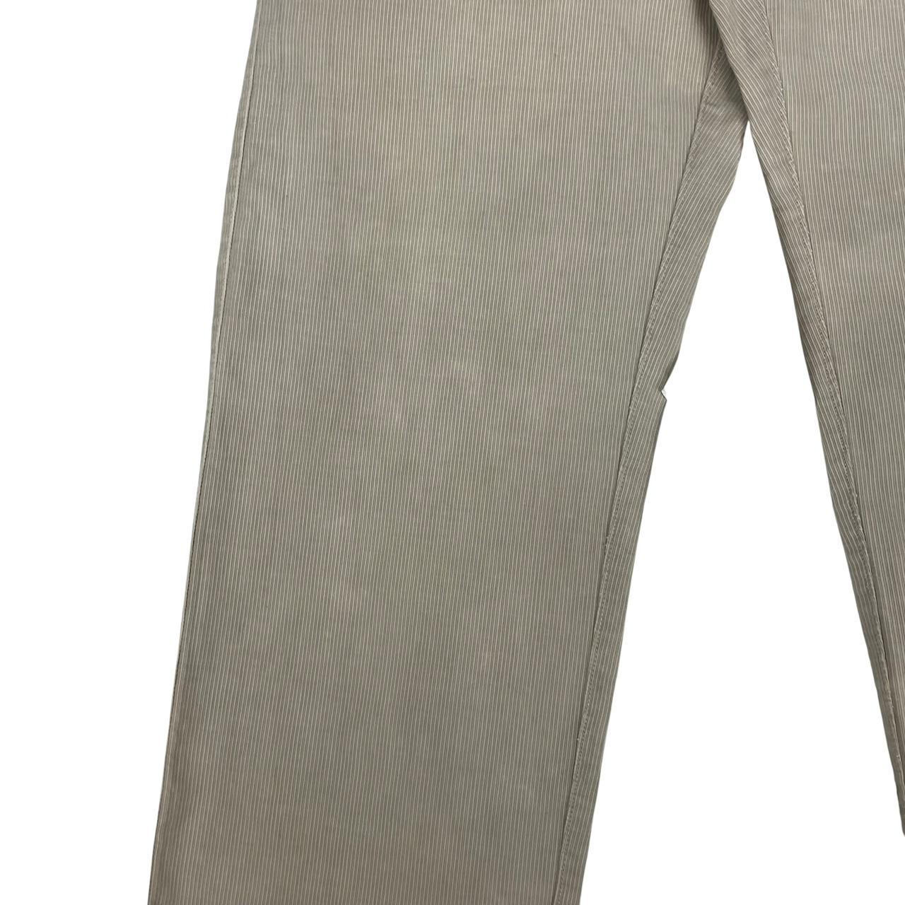 CP Company beige ribbed cotton trousers with faint stains and regular fit design.