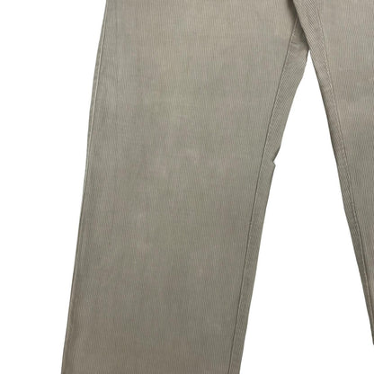 CP Company beige ribbed cotton trousers with faint stains and regular fit design.