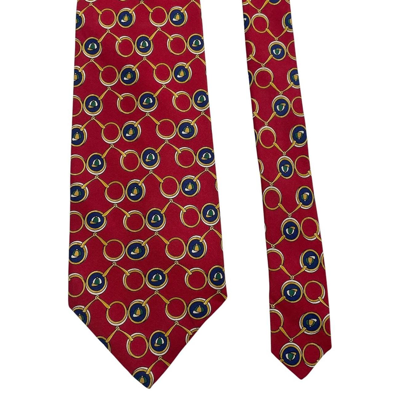 Burberry red silk tie featuring vintage horsebit print design.