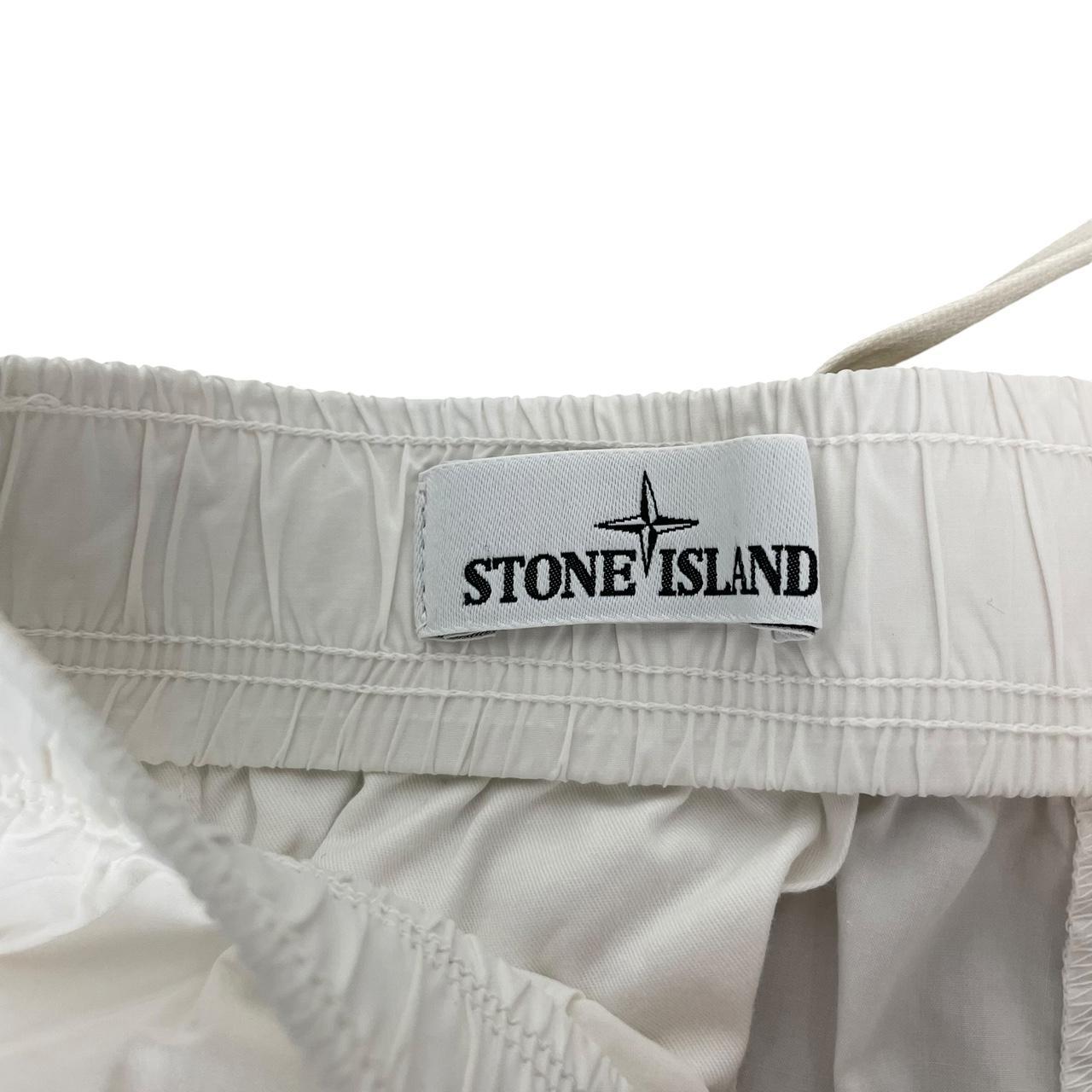 Stone Island white and yellow trousers with logo patch and RE-T fit design.