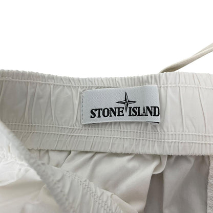 Stone Island white and yellow trousers with logo patch and RE-T fit design.