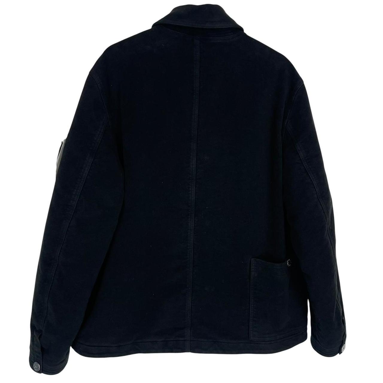 Stone Island navy blue work jacket with detachable compass badge and button-down closure.