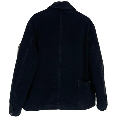 Stone Island navy blue work jacket with detachable compass badge and button-down closure.