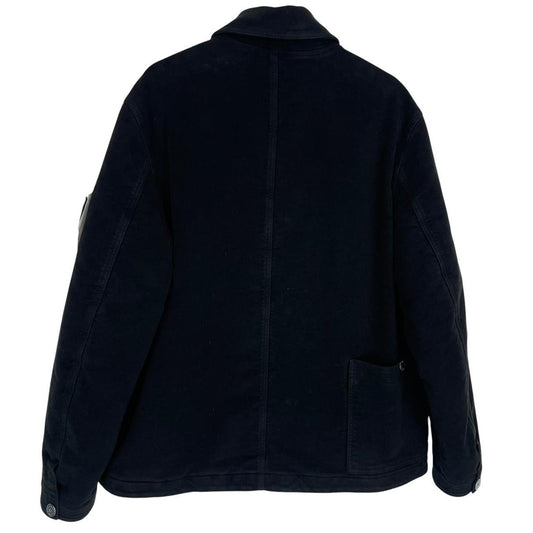 Stone Island navy blue work jacket with detachable compass badge and button-down closure.